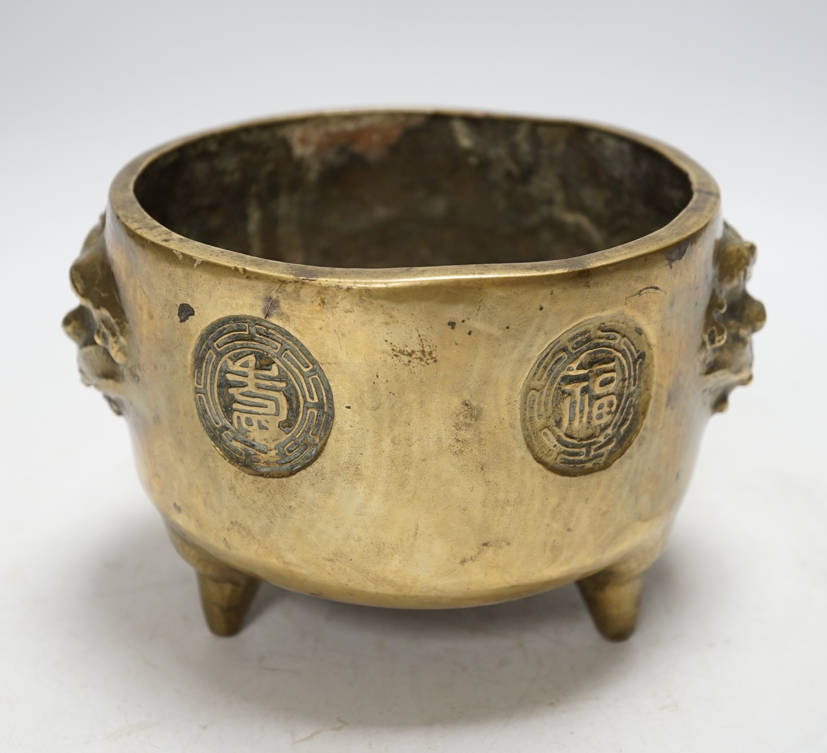 A Chinese bronze tripod censer, 18cm. Condition - fair to good